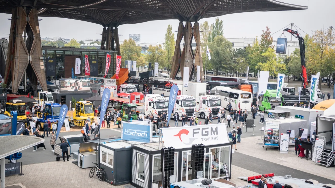Vehículos comerciales, stands y visitantes en el área exterior de IAA Transportation